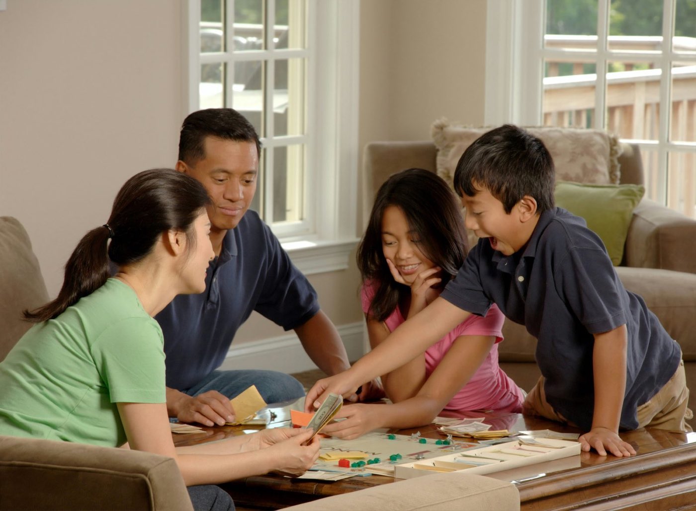 A family playing a board game together in their living room